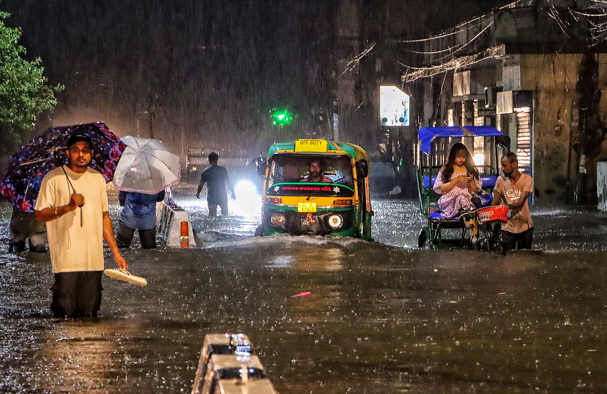 PTI : People wade through a waterlogged road during rain at Jangpura area, in New Delhi, Wednesday, July 31, 2024
